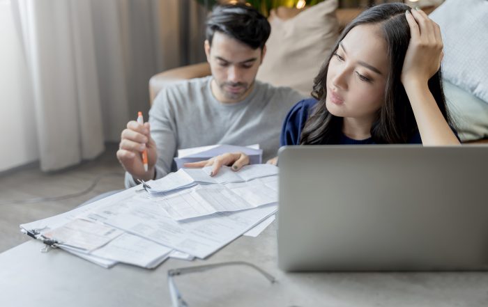 home-financehusband-wife-discussing-paper-bill-receipt-together-with-stress-confused-feeling-with-many-problem-debt-home-interior-background couple discussing financial problem