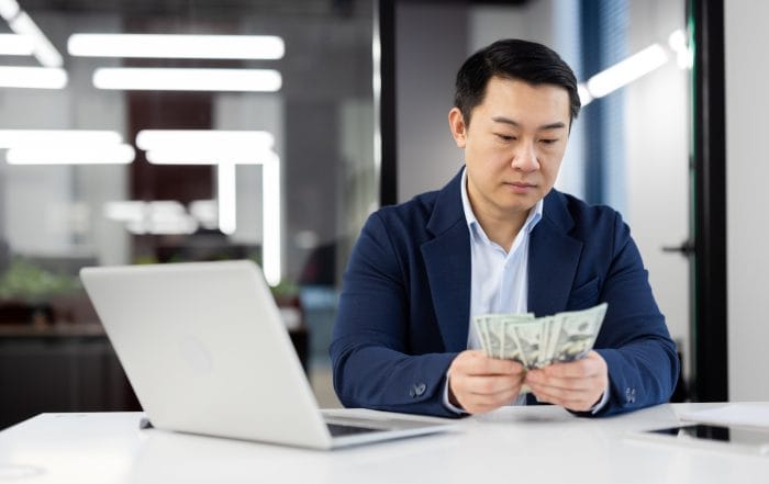 Businessman analyzing budget at modern office desk